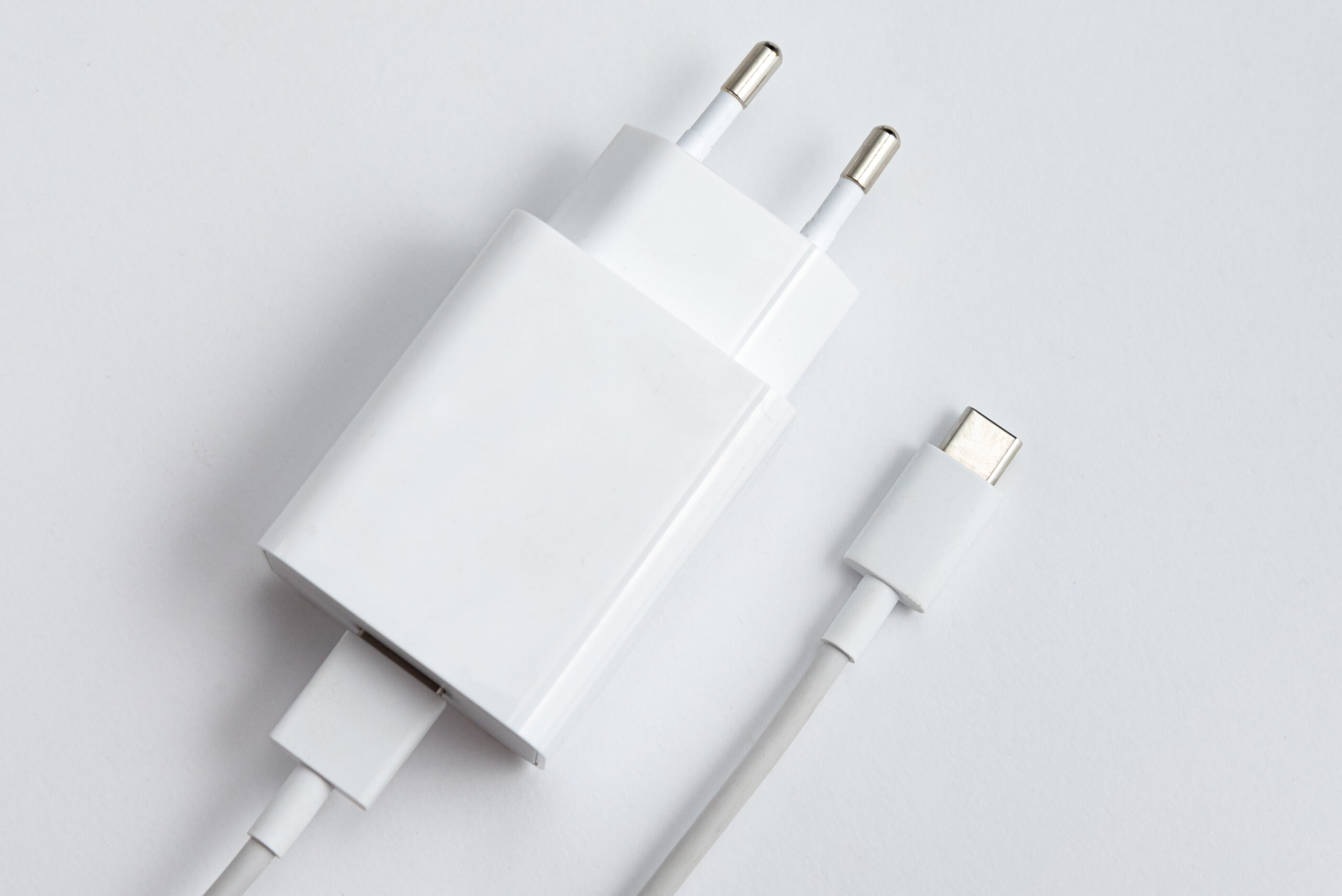 Charger and USB cable type C over white isolated background